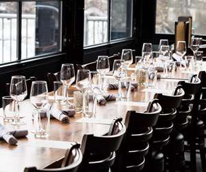 Table set with wine glasses and place settings for an event