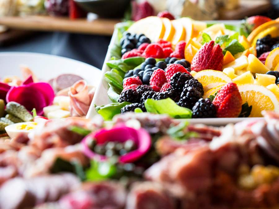 an assortment of fruit and charcuterie boards are shown