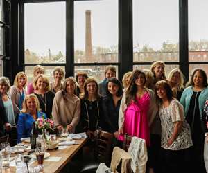 Guests posing in the GH during a baby shower event