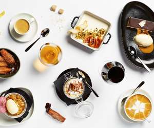 Overhead shot of various menu items plated on a white background