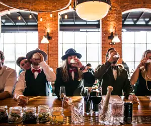 Guests taking a shot at the bar during a wedding buyout